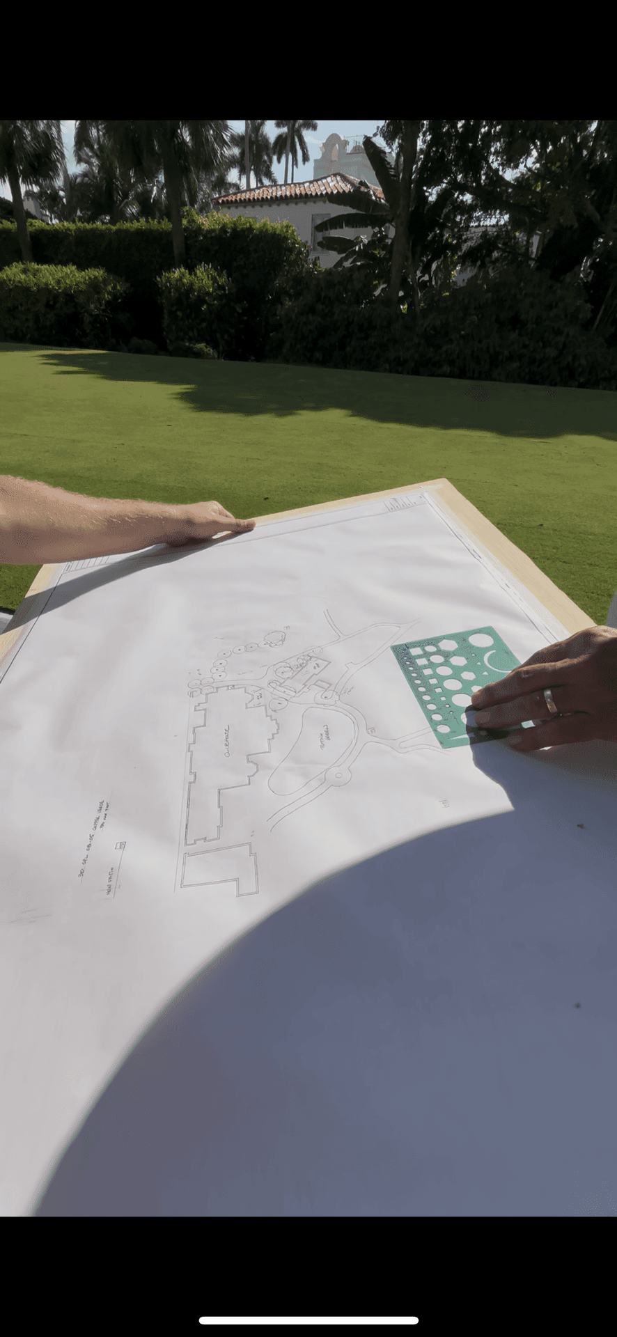 Hand sketching a golf course lighting design with a template on drafting paper